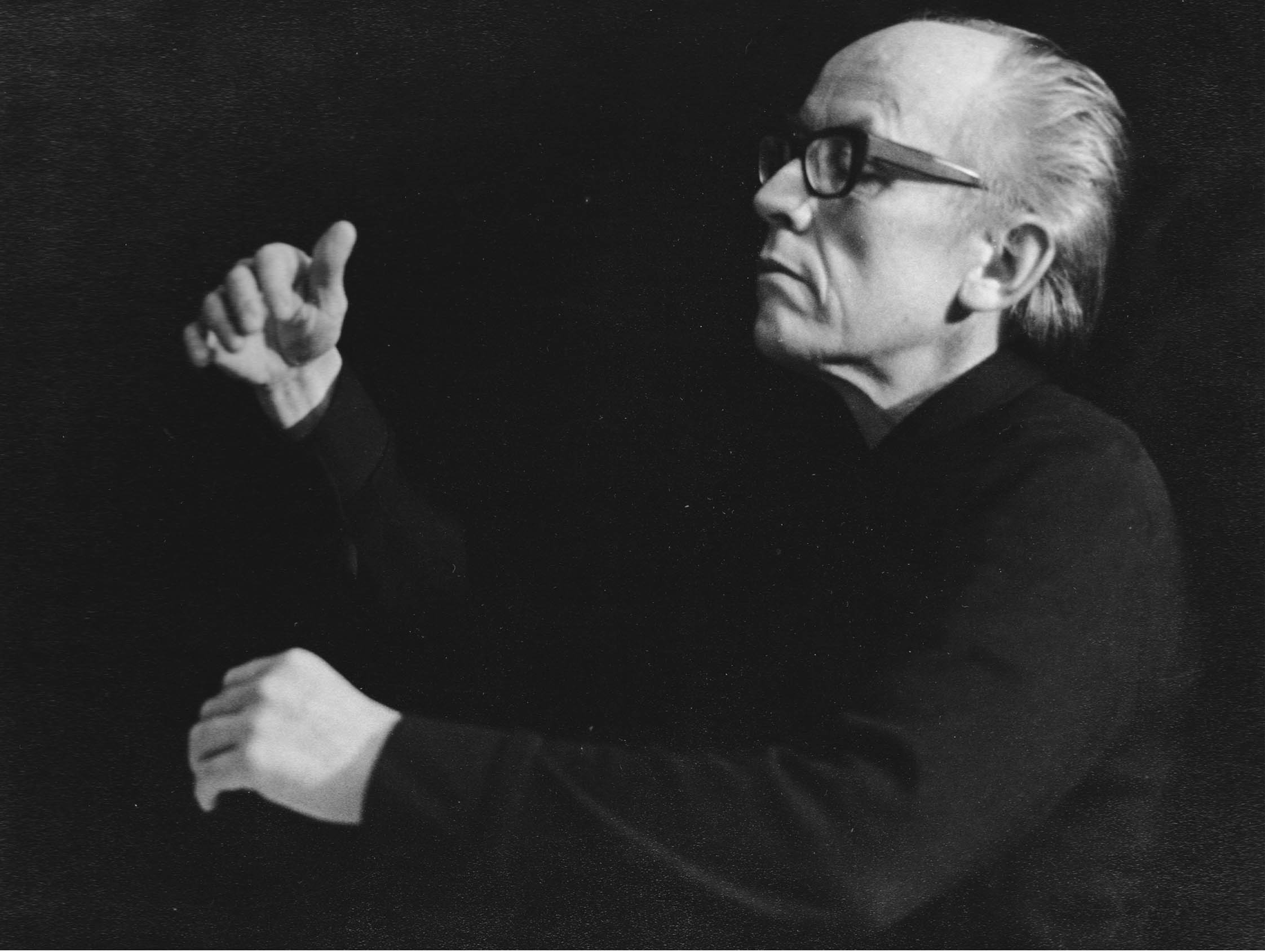 Black and white photo of Knut Nystedt conducting.